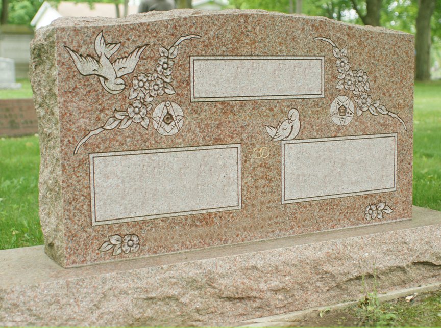 Rose granite companion upright with a rock pitched natural edge, carved doves, dogwood blossom and fraternal emblems, standing in a cemetery